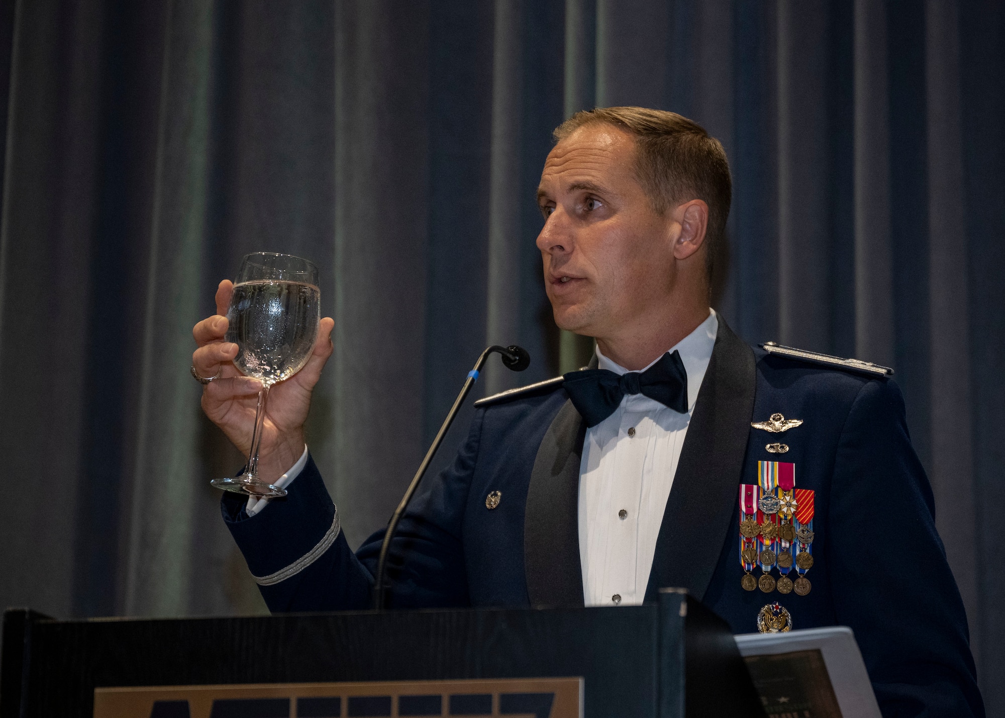 Col. Lucas Teel, 4th Fighter Wing commander, presents a toast during the Air Force Ball in Goldsboro, North Carolina, Sep. 16, 2023. The guest speaker for the event, Col. Norman McDaniel, is a Vietnam War veteran who spent six years as a prisoner of war. (U.S. Air Force photo by Senior Airman David Lynn)