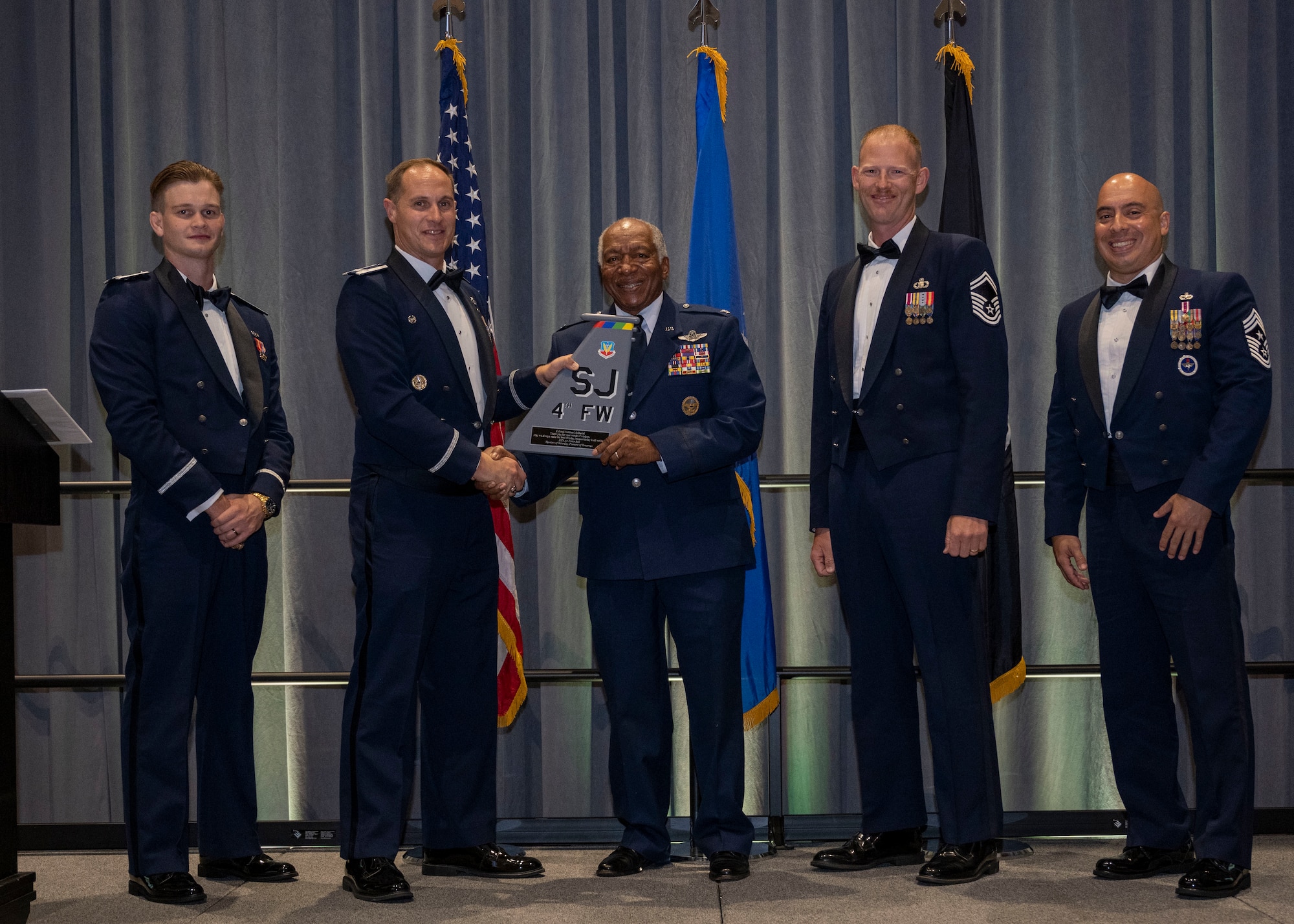 Col. Lucas Teel, left, presents an award to Col. Normal McDaniel, retired Vietnam War vet, during the Air Force Ball in Goldsboro, North Carolina, Sep. 16, 2023. McDaniel was chosen as the guest speaker to match the year’s theme which was focused on the 50th anniversary of the end of the Vietnam War. (U.S. Air Force photo by Senior Airman David Lynn)