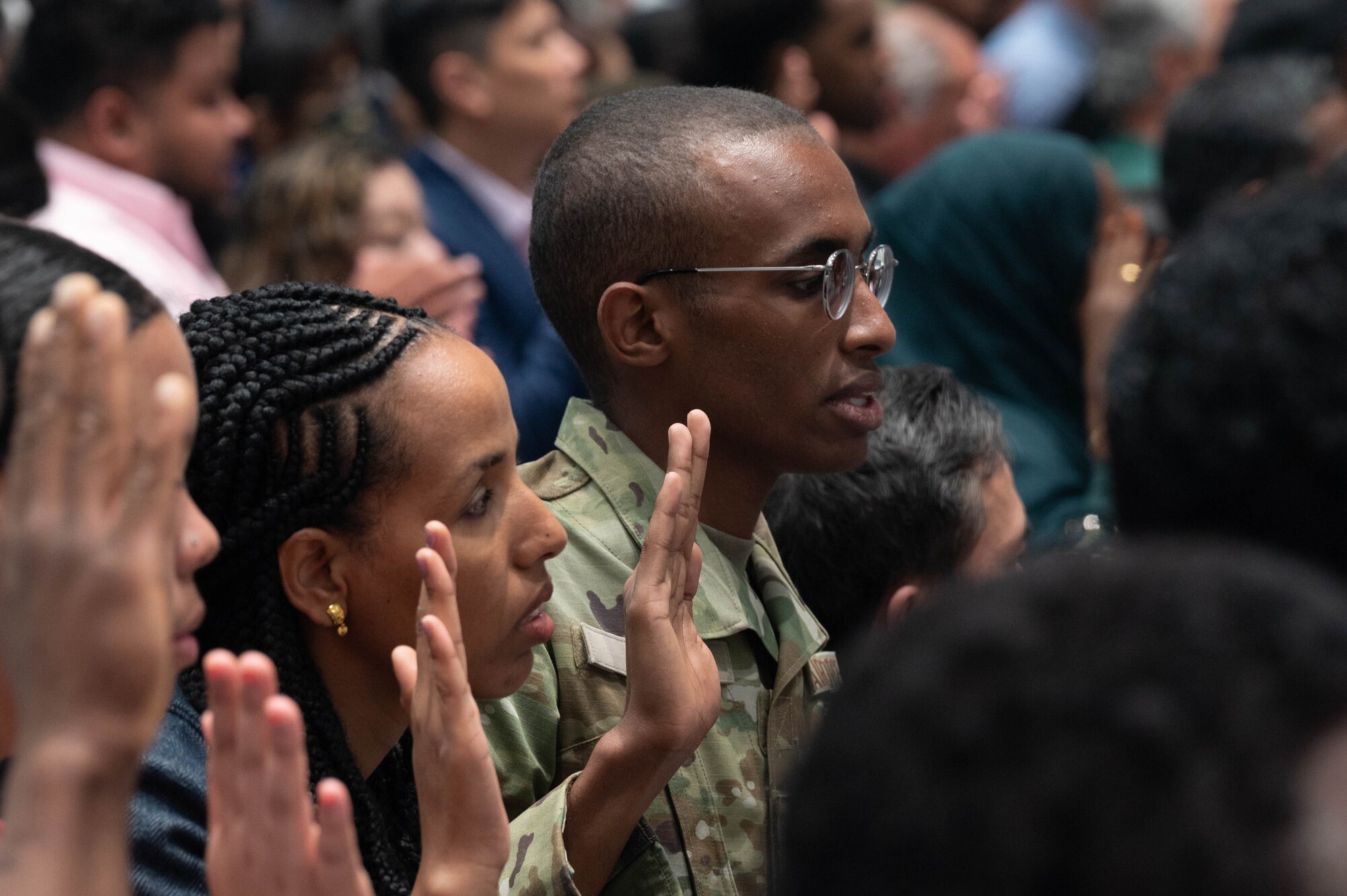 Senior Airman Mohammed Abdi, 934th Aeromedical Staging Squadron medical technician, recites the Naturalization Oath of the United States during a naturalization ceremony at the Xcel Energy Center, St. Paul, Minn., July 14, 2023. Before Abdi became an American, he took the Oath of Enlistment in 2020 to join the Air Force Reserve and become an Airman in the 934th Airlift Wing.