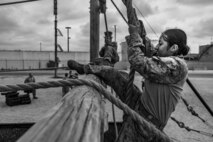 U.S. Marine Corps recruit Leslye Molina, with Golf Company, 2nd Recruit Training Battalion, navigates a rope obstacle during a confidence course event at Marine Corps Recruit Depot San Diego, Sept. 18, 2023.