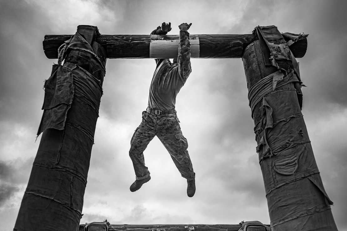A U.S. Marine Corps recruit with Golf Company, 2nd Recruit Training Battalion, navigates a log obstacle during a confidence course event at Marine Corps Recruit Depot San Diego, Sept. 18, 2023.