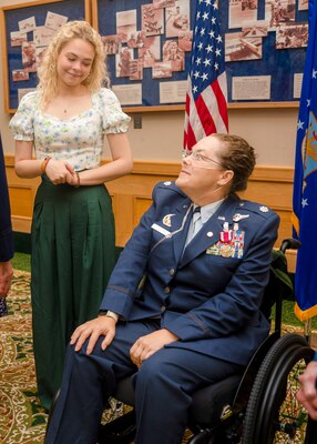 Lt. Col. (ret.) Dana Duerr, who recently served as Senior Program Manager of the Nurse Corps Education and Training at Air Force Medical Readiness Agency, and her daughter, Mikaela, share an expression of love during Duerr’s retirement ceremony in the Gateway Club at Joint Base San Antonio-Lackland, Texas, Aug. 30, 2023. When Mikaela was growing up, she used to help her mother prepare mannequins that were used to train medics. (U.S. Air Force photo by Senior Airman Melody Bordeaux)