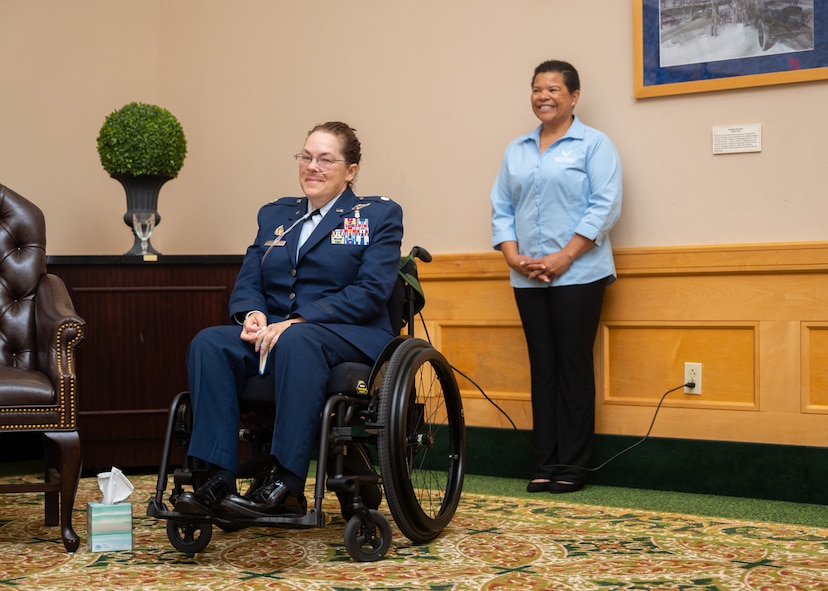 Lt. Col. (ret.) Dana Duerr, who recently served as Senior Program Manager of the Nurse Corps Education and Training Program at Air Force Medical Readiness Agency, sits in her wheelchair during her retirement ceremony in the Gateway Club at Joint Base San Antonio-Lackland, Texas, Aug. 30, 2023. Duerr was honored as an outstanding flight nurse, educator and warrior throughout her career of over 29 years. (U.S. Air Force photo by Senior Airman Melody Bordeaux)