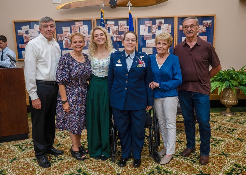 Lt. Col. (ret.) Dana Duerr, who recently served as Senior Program Manager of the Nurse Corps Education and Training at Air Force Medical Readiness Agency, and her family pose for a photo during her retirement ceremony in the Gateway Club at Joint Base San Antonio-Lackland, Texas, Aug. 30, 2023. Duerr was honored as an outstanding flight nurse, educator and warrior throughout her career of over 29 years. (U.S. Air Force photo by Senior Airman Melody Bordeaux)