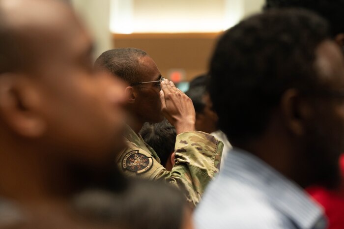 Senior Airman Mohammed Abdi, 934th Aeromedical Staging Squadron medical technician, renders a salute during the National Anthem at his naturalization ceremony at the Xcel Energy Center, St. Paul, Minn., July 14, 2023. Before Abdi became an American, he took the Oath of Enlistment in 2020 to join the Air Force Reserve and become an Airman in the 934th Airlift Wing.