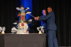 U.S. Air Force Lt. Gen. Scott Pleus, U.S. Forces Korea deputy commander, and Airman Jaylen Craig, 56th Security Forces Squadron defender, participate in the formal cake cutting ceremony during the 76th Air Force Ball, Sept. 16, 2023, at the Wigwam Resort, Litchfield Park, Arizona.
