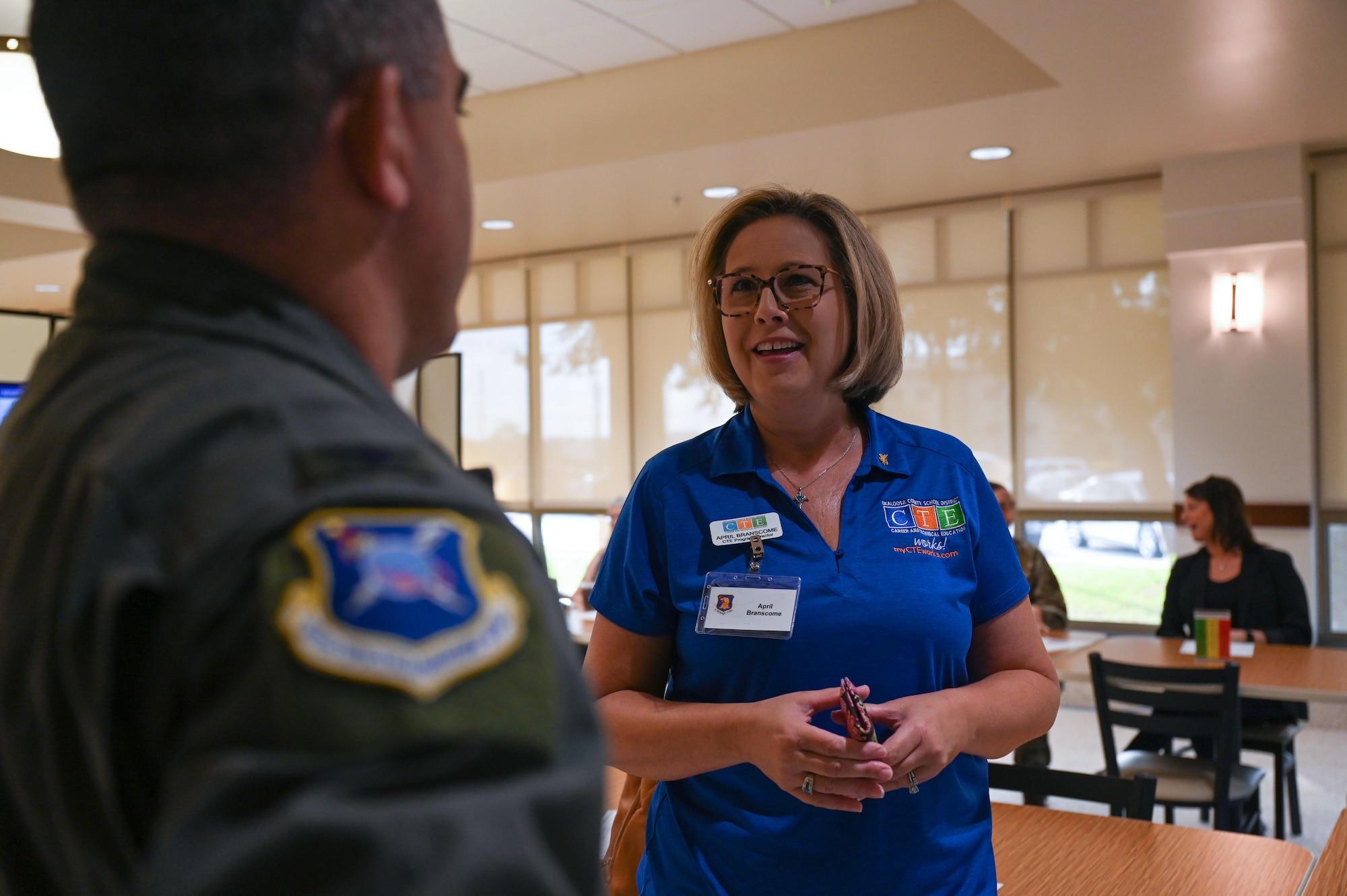 U.S. Air Force Col. Josh Koslov, 350th Spectrum Warfare Wing commander and April Branscome from Career & Technical Education, spoke during the 96th Test Wing quarterly community leader breakfast, at Eglin Air Force Base, Fla., Sept. 20, 2023. Such events bolster our community relationships, fostering connections with attendees from a range of backgrounds, including business leadership, real estate, higher education administration, chamber of commerce, and banking. (U.S. Air Force photo by Staff Sgt. Ericka A. Woolever)