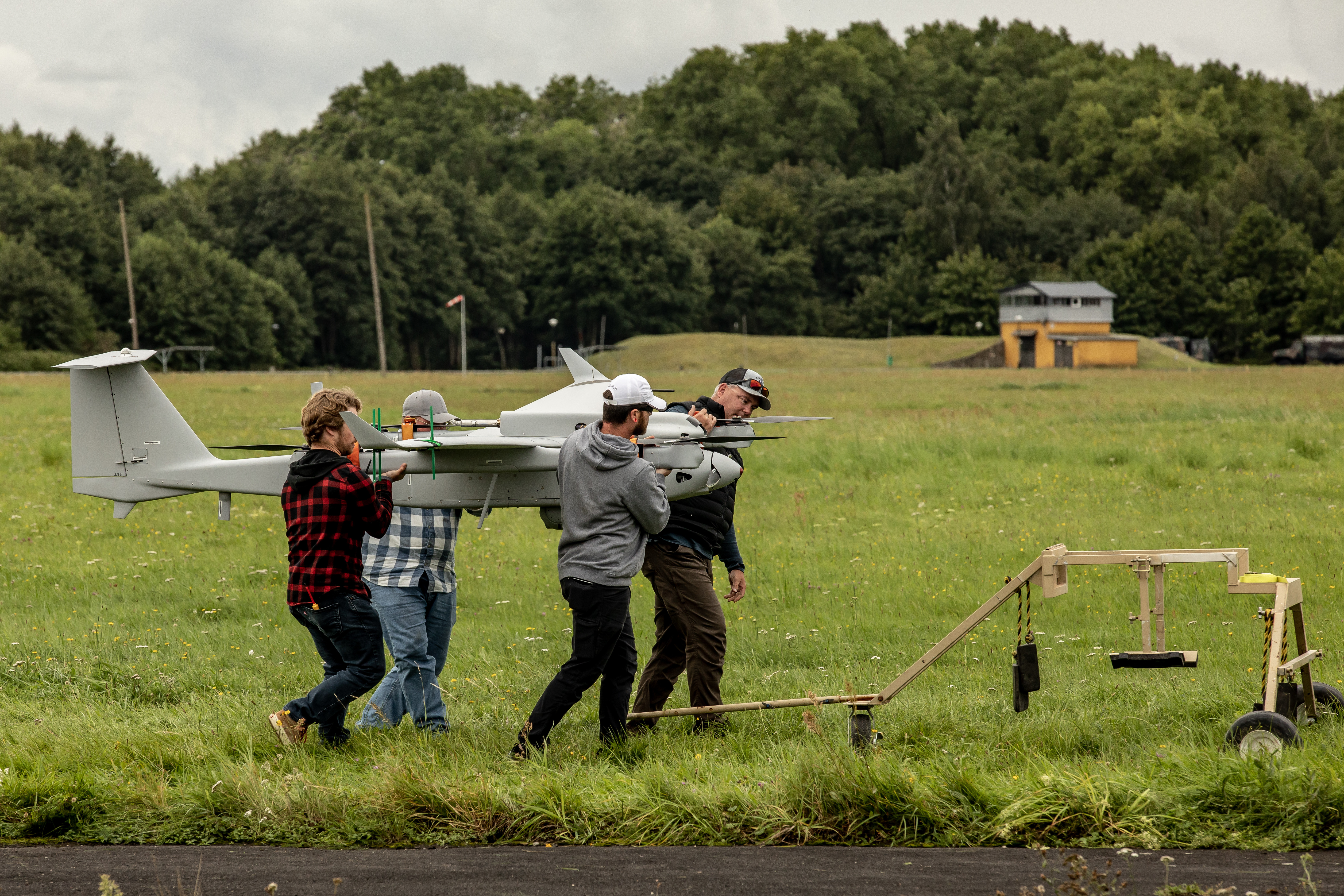 Contractors attached with the 2nd Multi-Domain Task Force, carry an aerial surveillance system after operating during exercise Arcane Thunder in Ustka, Poland Aug. 29.