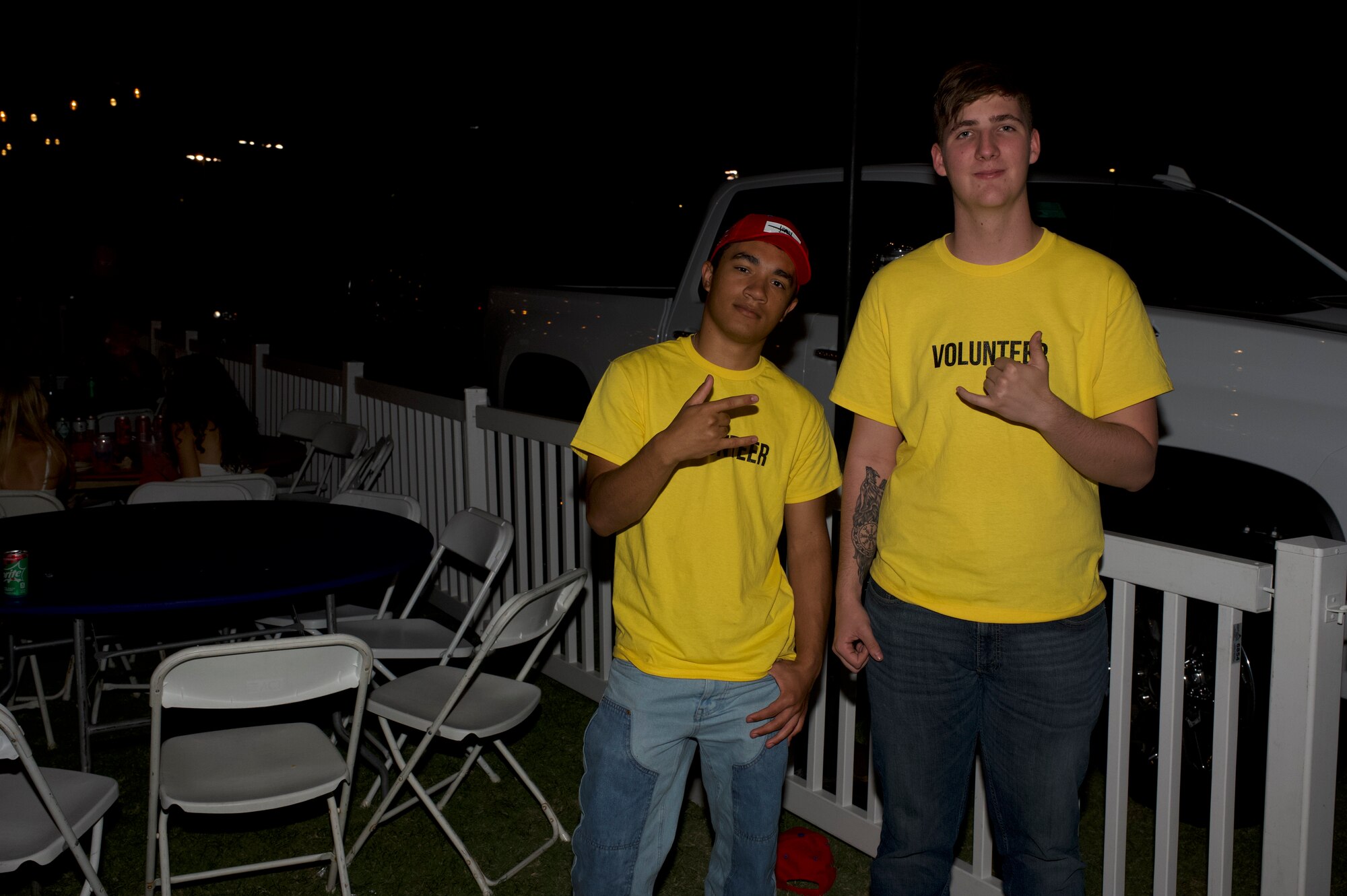 U.S. Air Force Airman 1st Class Gavin Partin, 355th Wing Munitions Squadron armament member specialist, and U.S. Air Force Airman 1st Class Max Velez, 357th Fighter Generation Squadron weapons specialist, pose for a photo at the end of the DM50 tailgate in Tucson, Ariz., Sept. 16, 2023. Davis-Monthan Air Force Base volunteers were present for the entire tailgate as security and event organizers. (U.S. Air Force photo by Airman 1st Class Robert Allen Cooke III)
