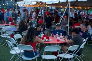 Civilians and Davis-Monthan Air Force Base Volunteers participate in the DM50 tailgate in Tucson, Ariz., Sept. 16, 2023. Volunteers acted as event security and set up the event. (U.S. Air Force photo by Airman 1st Class Robert Allen Cooke III)