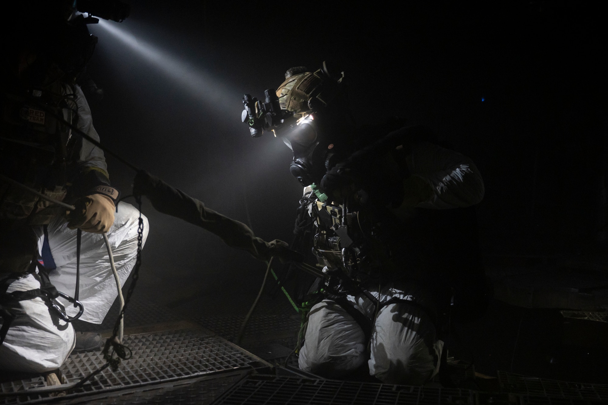 A photo of a U.S. Airman, training with the 68th Rescue Squadron, is lowered into the deepest section of a missile silo during a Combat Leader Course training exercise at the Titan Missile Museum.