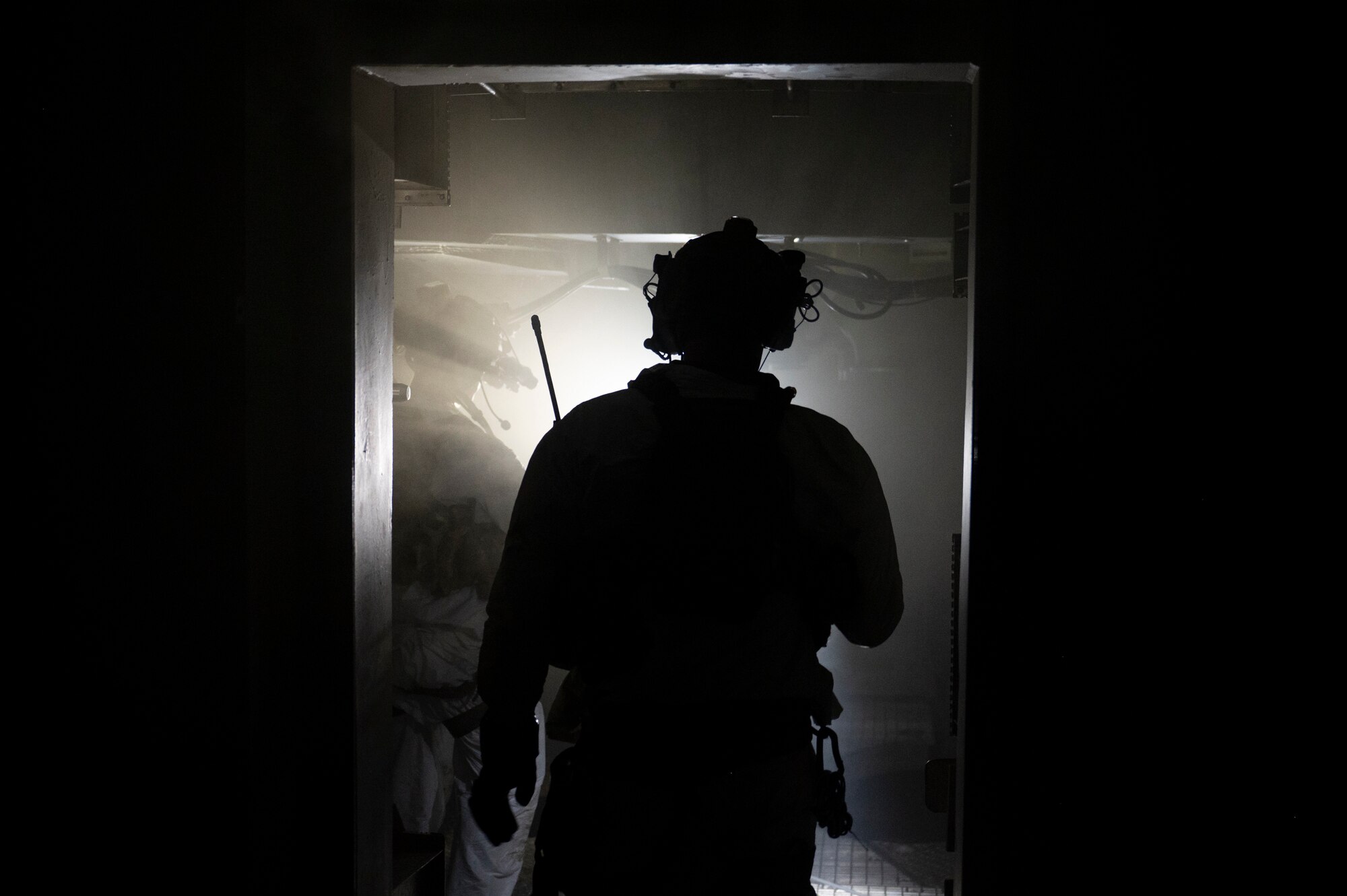 A photo of a U.S. Airman, training with the 68th Rescue Squadron, enters the staging area during a Combat Leader Course training exercise at the Titan Missile Museum.