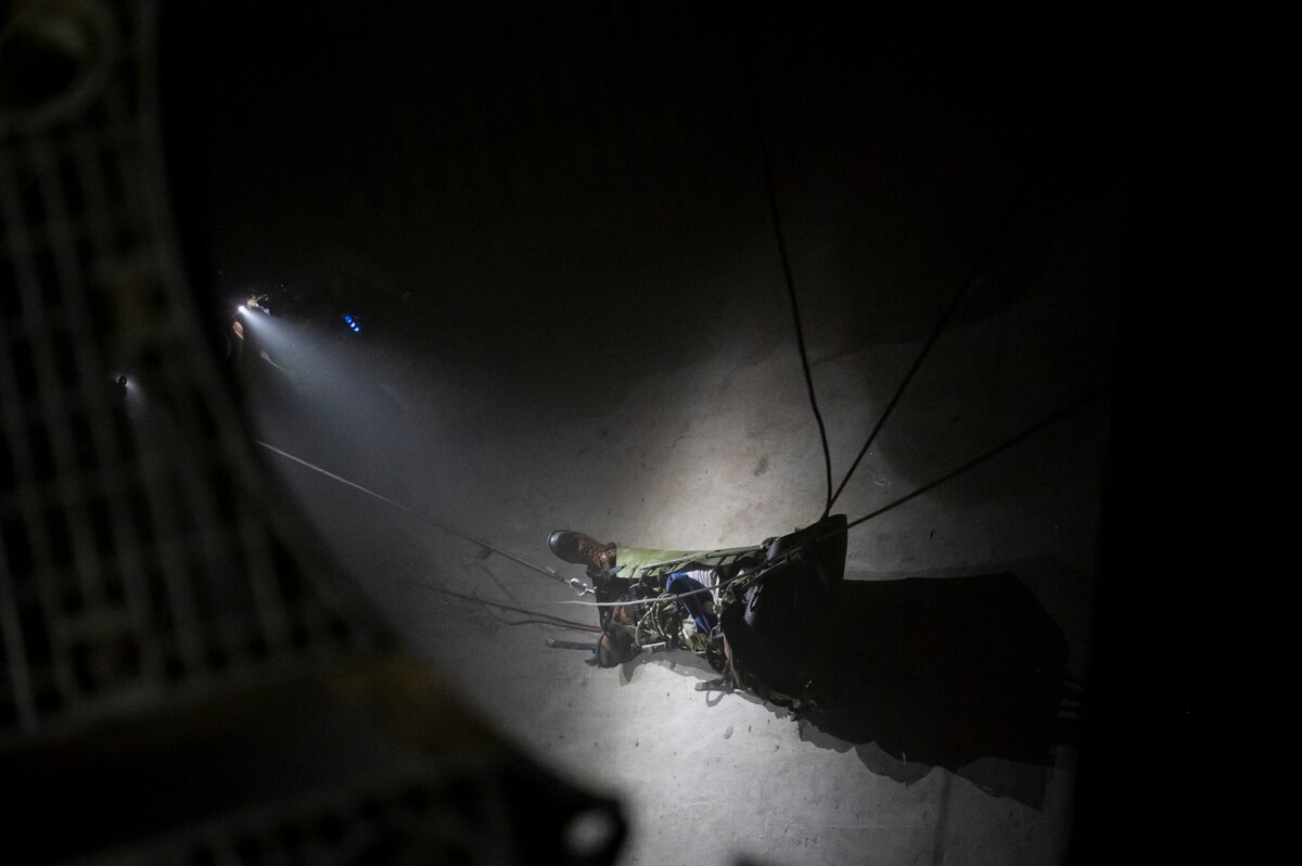 A photo of a U.S. Airman, acting as a simulated casualty for the 68th Rescue Squadron’s Combat Leader Course, is lifted via rope system during a training exercise at the Titan Missile Museum.
