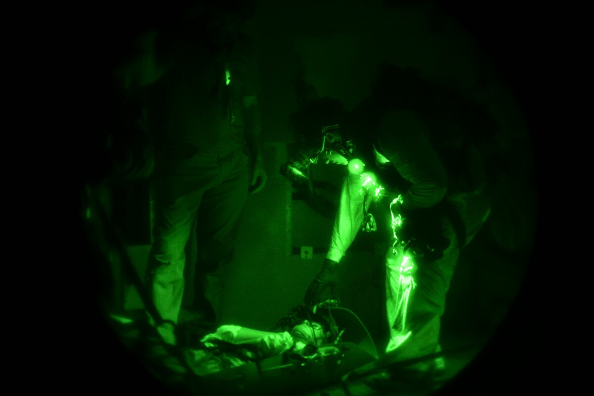 A photo of a U.S. Airman, training with the 68th Rescue Squadron, checks a simulated casualty at Titan Missile Museum.