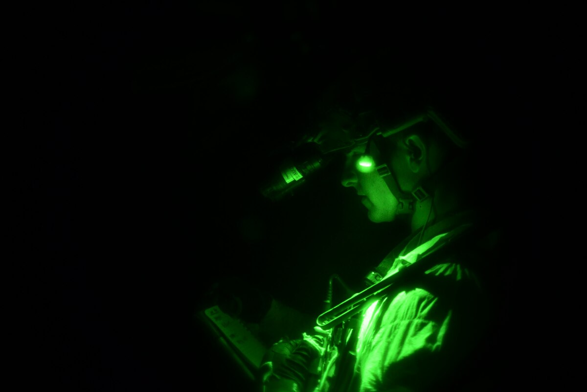 A photo of a U.S. Airman, training with the 68th Rescue Squadron, checks his notes during the Combat Leader Course at the Titan Missile Museum.