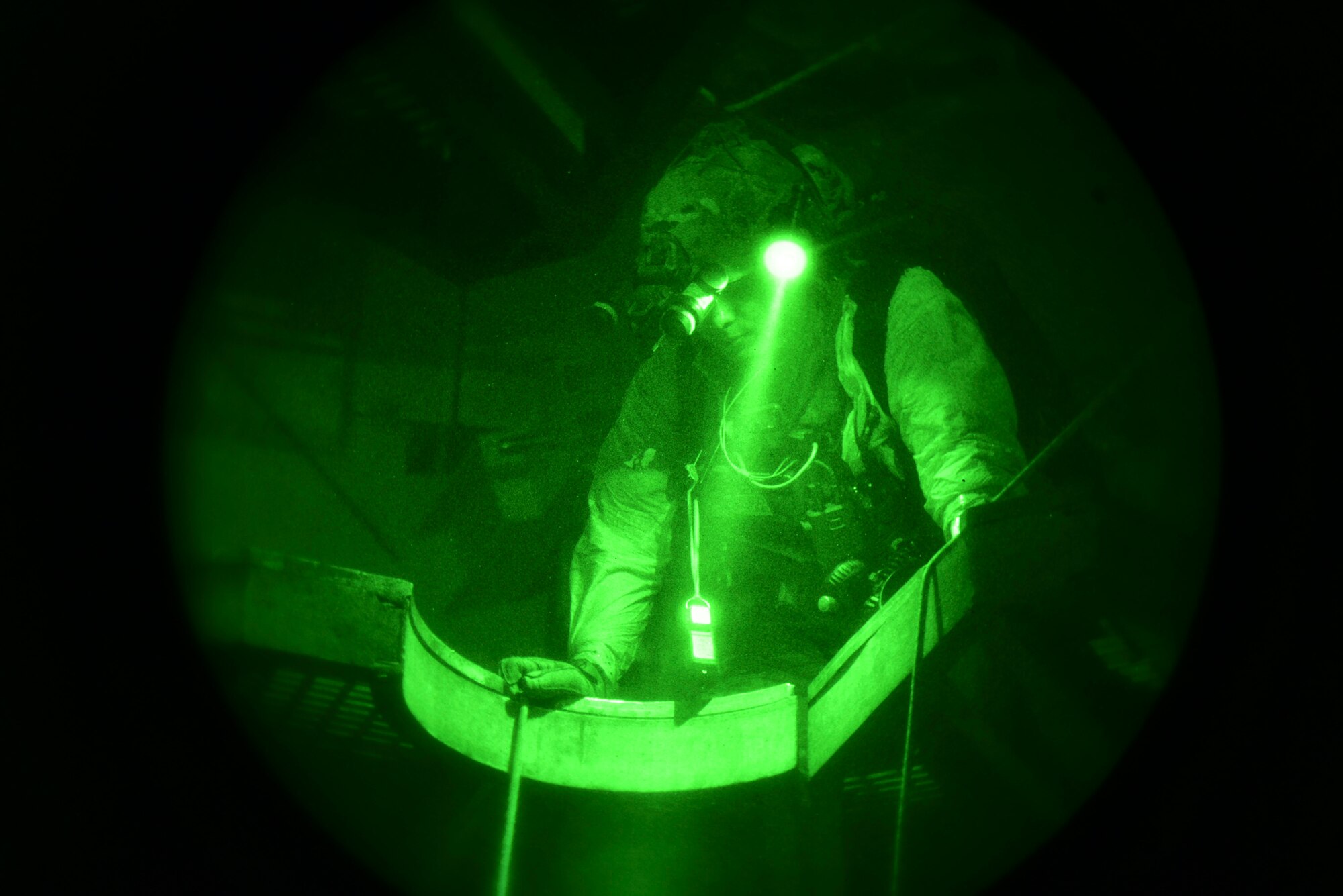 A photo of a U.S. Airman, training with the 68th Rescue Squadron, communicates with his teammate at the bottom of the Titan Missile Museum.