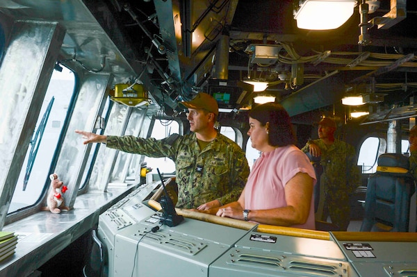 Capt. Marc Crawford, left, commodore of Littoral Combat Ship Squadron ONE, speaks to Natasha Fyles, center, the Australian Chief Minister of Northern Territory, on the bridge of the Independence-variant littoral combat ship USS Canberra (LCS 30) during a scheduled tour, Sept. 11, 2023.