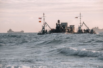 Army mariners aboard a causeway ferry come ashore as part of the Joint Logistics Over-the-Shore operation during Talisman Sabre 2023 in Bowen, Australia, July 31, 2023. JLOTS demonstrates the critical capability of bringing vehicles and equipment to the shore in austere environments or when port facilities are unavailable. Talisman Sabre is the largest bilateral military exercise between Australia and the United States, with multinational participation, advancing a free and open Indo-Pacific by strengthening relationships and interoperability among key allies and enhancing our collective capabilities to respond to a wide array of potential security concerns.