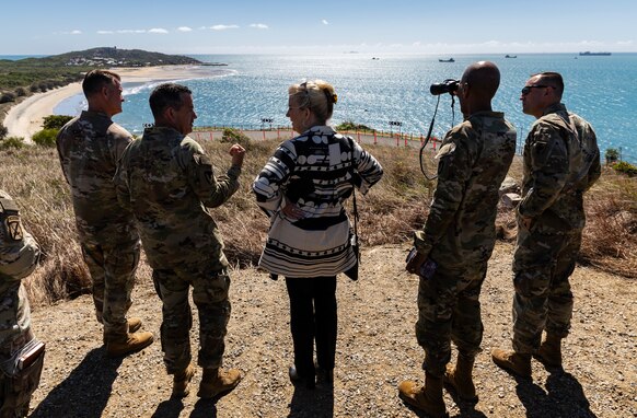 The Secretary of the Army Christine Wormuth, center, along with senior U.S. Army leaders, stand at an overlook for the Joint Logistics Over-the-Shore operation during Talisman Sabre 2023 in Bowen, Australia, July 29, 2023. JLOTS demonstrates the critical capability of bringing vehicles and equipment to the shore in austere environments or when port facilities are unavailable. Talisman Sabre is the largest bilateral military exercise between Australia and the United States, with multinational participation, advancing a free and open Indo-Pacific by strengthening relationships and interoperability among key allies and enhancing our collective capabilities to respond to a wide array of potential security concerns. (Photo by ADF Senior Imagery Specialist Sergeant Sagi Biderman)