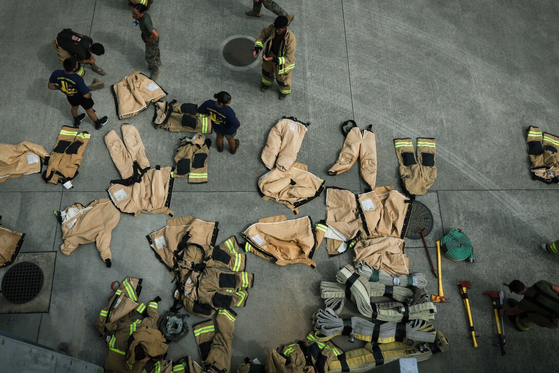 Fire fighter equipment is staged during the annual 9/11 memorial stair climb at Marine Corps Air Station Iwakuni, Japan, Sept. 8, 2023. Participants climbed 110 floors in honor of those who died during 9/11 and to simulate the same challenge New York City firefighters had to endure during rescue operations. (U.S. Marine Corps photo by Cpl. Darien Wright)
