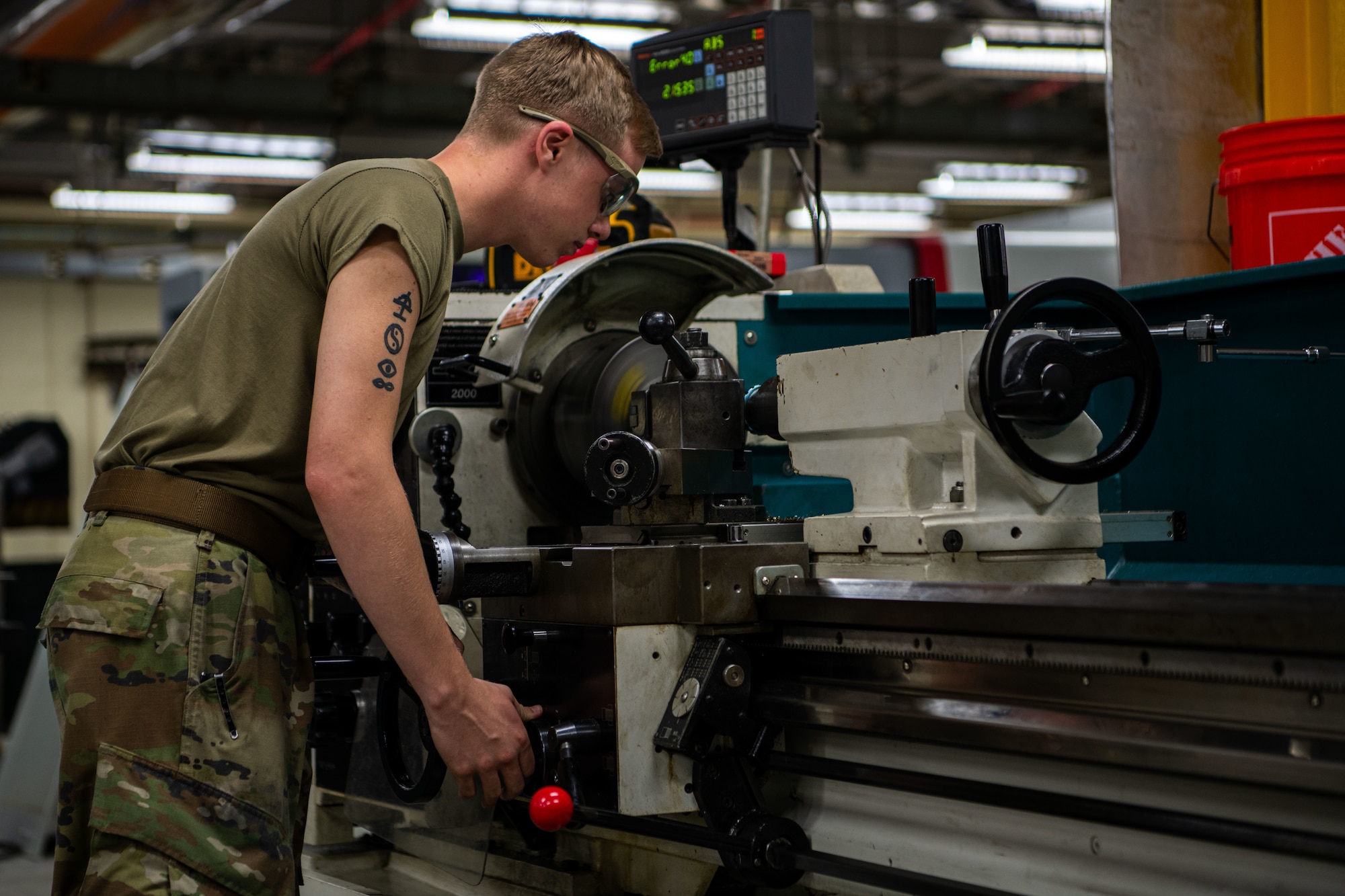 A metals technician operates a lathe.