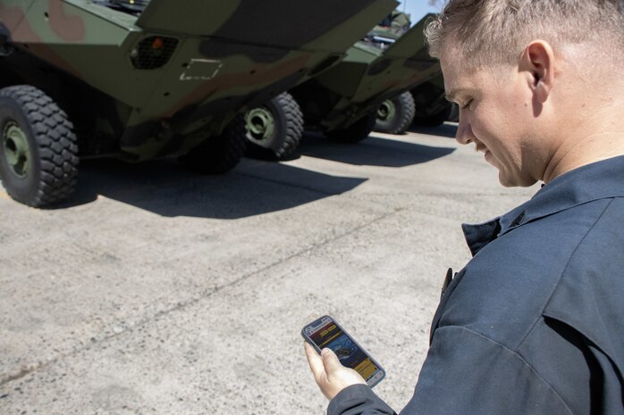 A Marine Corps Amphibious Combat Vehicle operator with the Program Executive Officer Land Systems’ Program Manager for Advanced Amphibious Assault New Equipment Training Team reviews the Assault Amphibian Community Website while inspecting a vehicle at Camp Pendleton, California, Sept. 14, 2023.