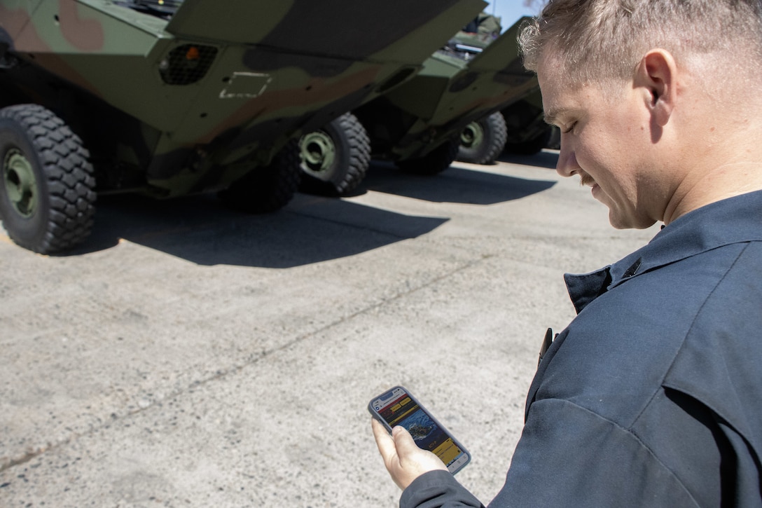 A Marine Corps Amphibious Combat Vehicle operator with the Program Executive Officer Land Systems’ Program Manager for Advanced Amphibious Assault New Equipment Training Team reviews the Assault Amphibian Community Website while inspecting a vehicle at Camp Pendleton, California, Sept. 14, 2023. To provide an easily accessible, centralized knowledge hub for the Corps’ amphibious vehicle community, PEO Land Systems’ PM AAA and Marine Corps Systems Command’s Marine Corps Tactical Systems Support Activity recently partnered to launch the game-changing new site. (Marine Corps photo by Mark Hoots.)