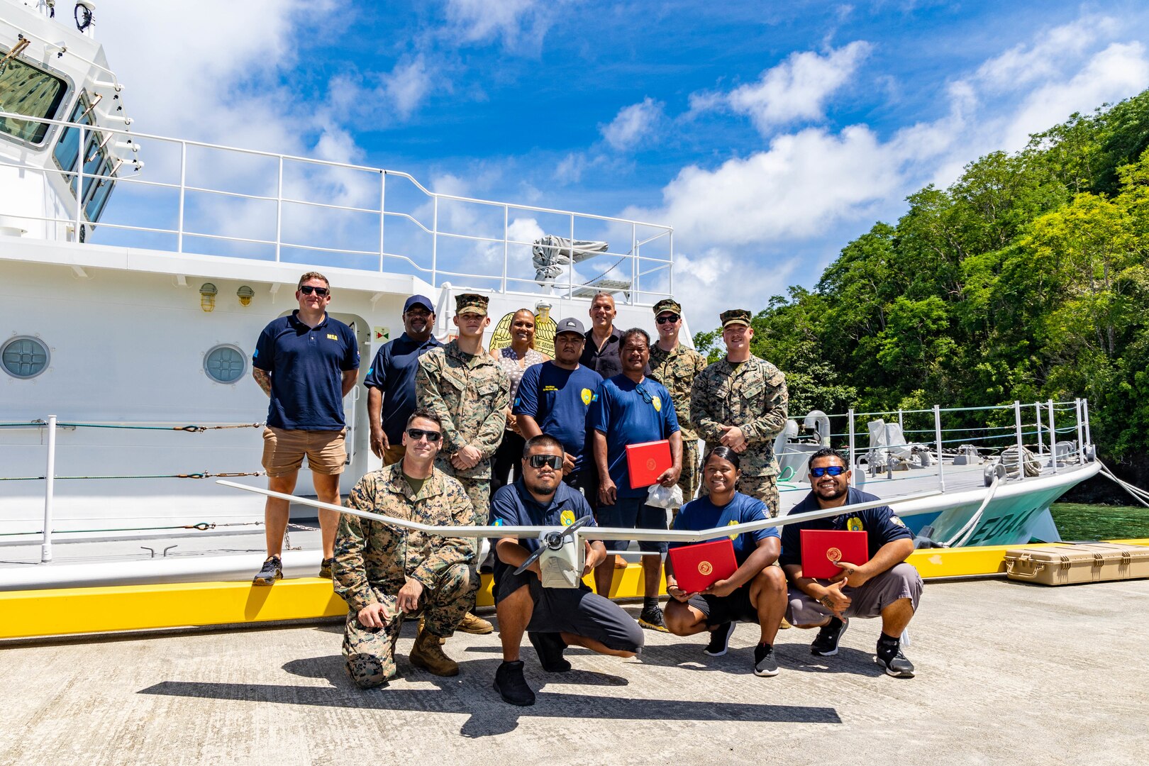 U.S. Marines with Task Force Koa Moana 23 and Palauan Maritime Law Enforcement Officers pose for a photograph at the conclusion of the Task Force Koa Moana RQ-20B Puma Training Course graduation at the Palau Joint Operations Center, Bureau of Maritime Security and Fish & Wildlife Protection, Koror, Palau, Sept. 14, 2023. Task Force Koa Moana 23, composed of U.S. Marines and Sailors from I Marine Expeditionary Force, deployed to the Indo-Pacific to strengthen relationships with Pacific Island partners through bilateral and multilateral security cooperation and community engagements. (U.S. Marine Corps photo by Staff Sgt. Courtney G. White)