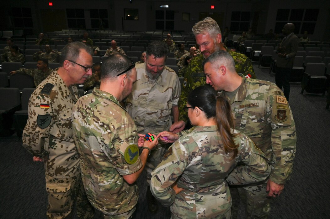 Students in the 2023 International Senior Non-Commissioned Officer Development course participate in a critical thinking activity at the Inter-American Air Forces Academy on Joint Base San Antonio-Lackland, Texas, September 18, 2023. Retired Chief Master Sgt. Todd Simmons, former Chief Master Sgt. of Air University, led the critical thinking activity during his presentation to cultivate problem solving and teamwork. (U.S. Air Force photo by Senior Airman Brittany Wich)