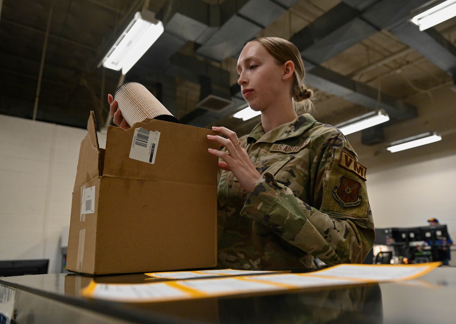 Airman 1st Class Alily Kliewer, 28th Logistics Readiness Squadron light ground vehicle fleet management and analysis technician, receives an oil filter from a placed order, Sept. 8, 2023, at Ellsworth Air Force Base, South Dakota.
