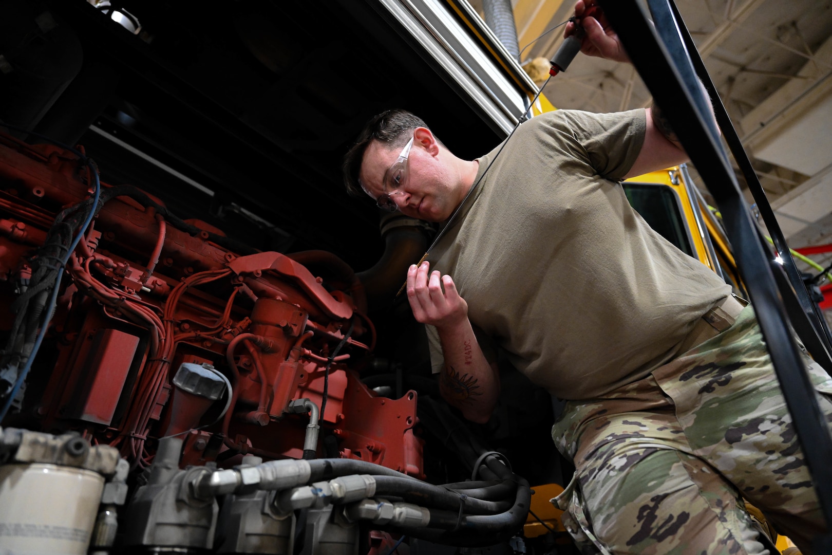 Tech. Sgt. Anthony Tavares, 28th Logistics Readiness Squadron light ground vehicle noncommissioned in charge of special purpose vehicle maintenance, inspects oil levels for a flightline snow broom , Sept. 8, 2023, at Ellsworth Air Force Base, South Dakota.