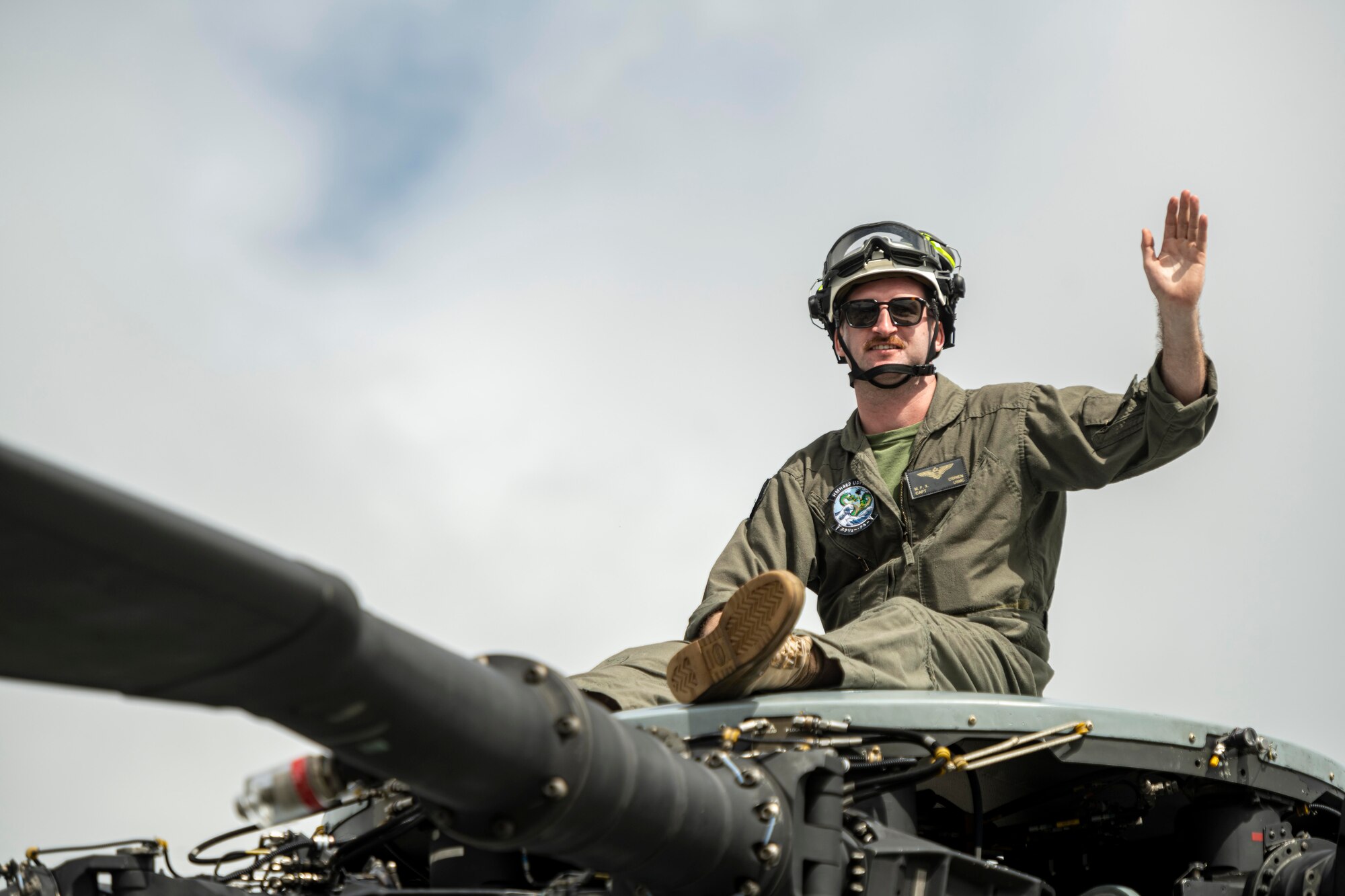 Airmen sits on top of a CH-47 Chinook during Misawa Air Fest 2023.