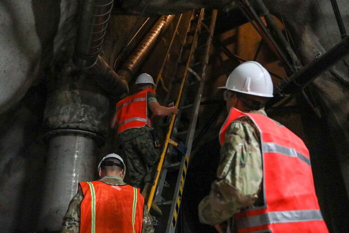 Joint Task Force-Red Hill (JTF-RH) communications directorate personnel climb a ladder in the Red Hill Bulk Fuel Storage Facility, Halawa, Hawaii, Sept. 14, 2023.