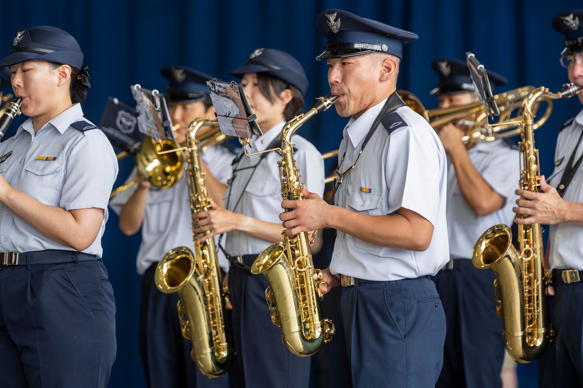 A group of Japanese military members play instruments.