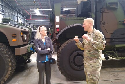 Army Col. Blake Smith, the commander of Army Field Support Battalion-Benelux, briefs the acting U.S. ambassador to the Netherlands, Aleisha Woodward, at the Eygelshoven Army Prepositioned Stocks-2 work site, Sept. 18. Woodward, whose permanent position at the U.S. embassy in the Netherlands is deputy chief of mission and deputy to the ambassador, visited the APS-2 site to see for herself how an APS-2 site operates in Europe. (U.S. Army courtesy photo)