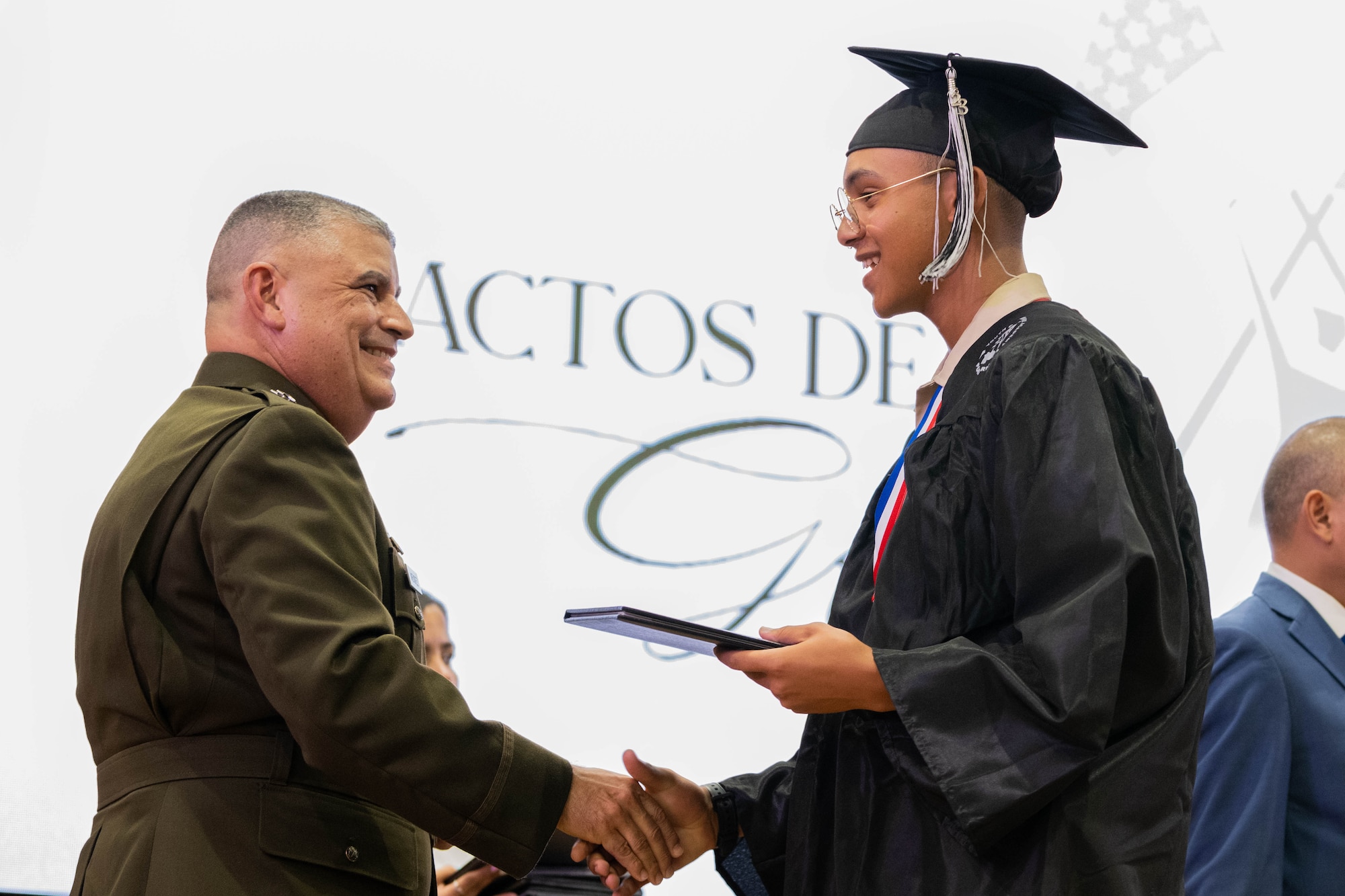 U.S. Army Maj. Gen. Miguel A. Mendez, the adjutant general of Puerto Rico, congratulates Cadet Jan Lopez with the Puerto Rico National Guard Youth ChalleNGe Academy, 3rd Platoon, Wolfpack, Class 23-02, during his graduation ceremony at Pontifical Catholic University of Puerto Rico, Ponce, Puerto Rico, Sept. 15, 2023. Lopez received his high school diploma after completing the 22-week PRNG Youth ChalleNGe Academy program, where he studied for his high school diploma and also received vocational education from several career fields. (U.S. Air National Guard photo by 2nd. Lt. Eliezer Soto)