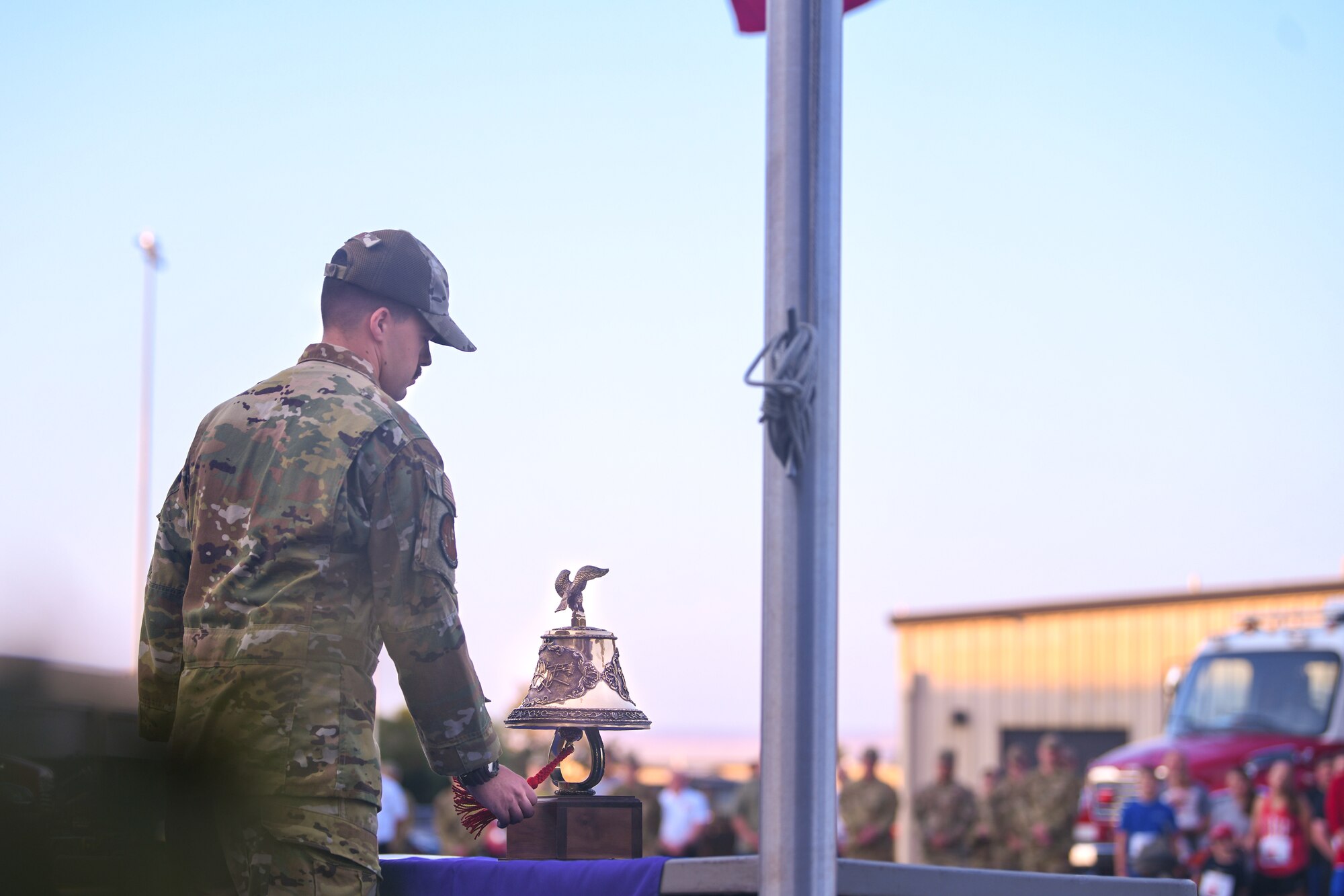 Airmen rings ceremonial bell during the 9/11 5k ceremony.