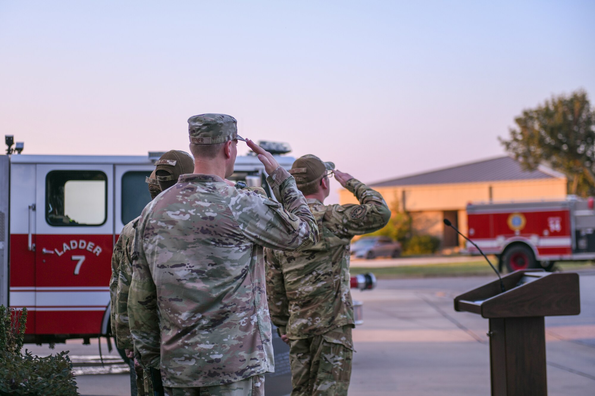 Airmen saluting to the United States flag during the 9/11 ceremony.