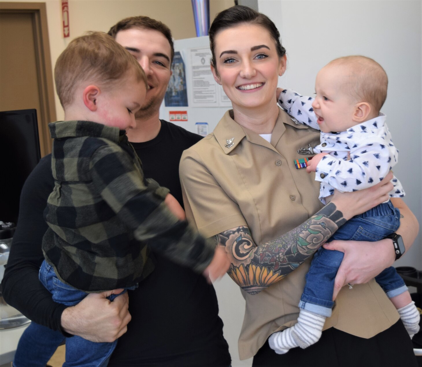 An Army and Navy family affair… Hospital Corpsman 2nd Class Ashley Painter is joined by husband Will and their two young sons for a photo-opportunity after her ceremoniously promotion to her current rank at Naval Hospital Bremerton (Official Navy photo by Douglas H Stutz, NHB/NMRTC Bremerton public affairs officer).