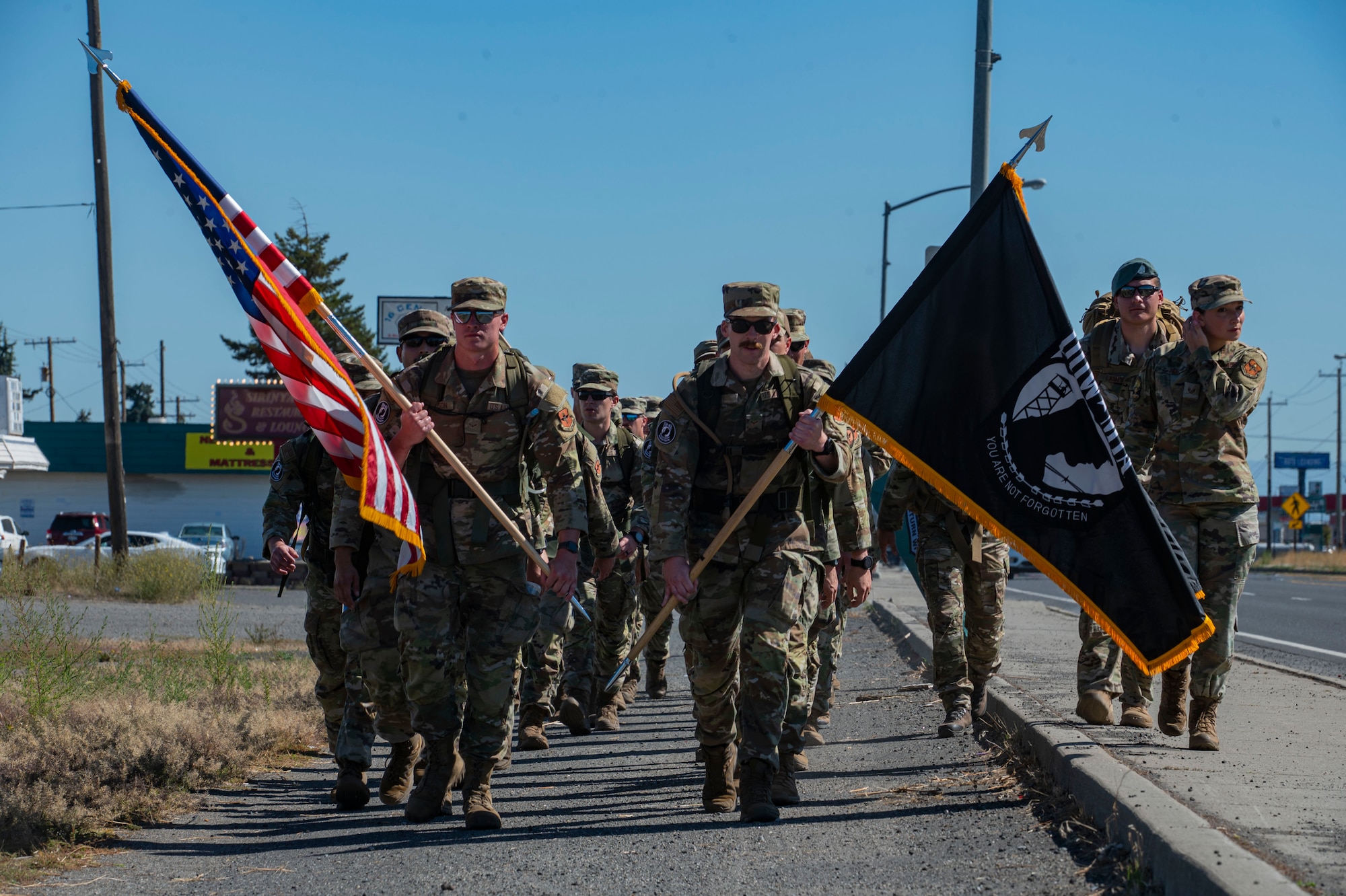 A formation of survival, evasion, resistance and escape candidates complete the first leg of a 24-hour ruck march in honor of National POW/MIA Recognition Day outside of the Veterans of Foreign Wars Post 3386 in Airway Heights, Washington, Sept. 14, 2023. During the ruck march, Airmen from Fairchild Air Force Base kept the POW/MIA flag in constant motion. The ruck march began on Sept. 14 at the Vietnam Veterans Memorial in downtown Spokane and continued through Airway Heights before concluding at Fairchild AFB. The event culminated with a recognition ceremony on Sept. 15 to honor all American prisoners of war and those Americans still missing in action, as well as their families. Every year, the third Friday in September is recognized in the United States as National POW/MIA Recognition Day. The Department of Defense is steadfast in its commitment to finding, recovering, identifying and repatriating the remains of its heroes who are unaccounted for.   (U.S. Air Force photo by Staff Sgt. Lawrence Sena)