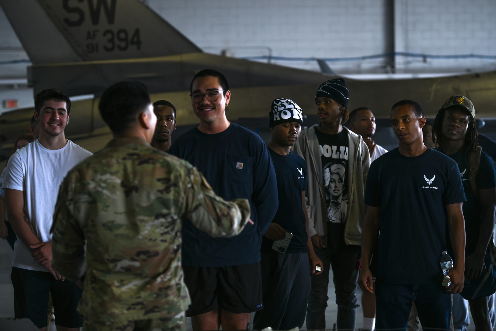 Recruits smile while they are being briefed by an Airman at Shaw Air Force Base.