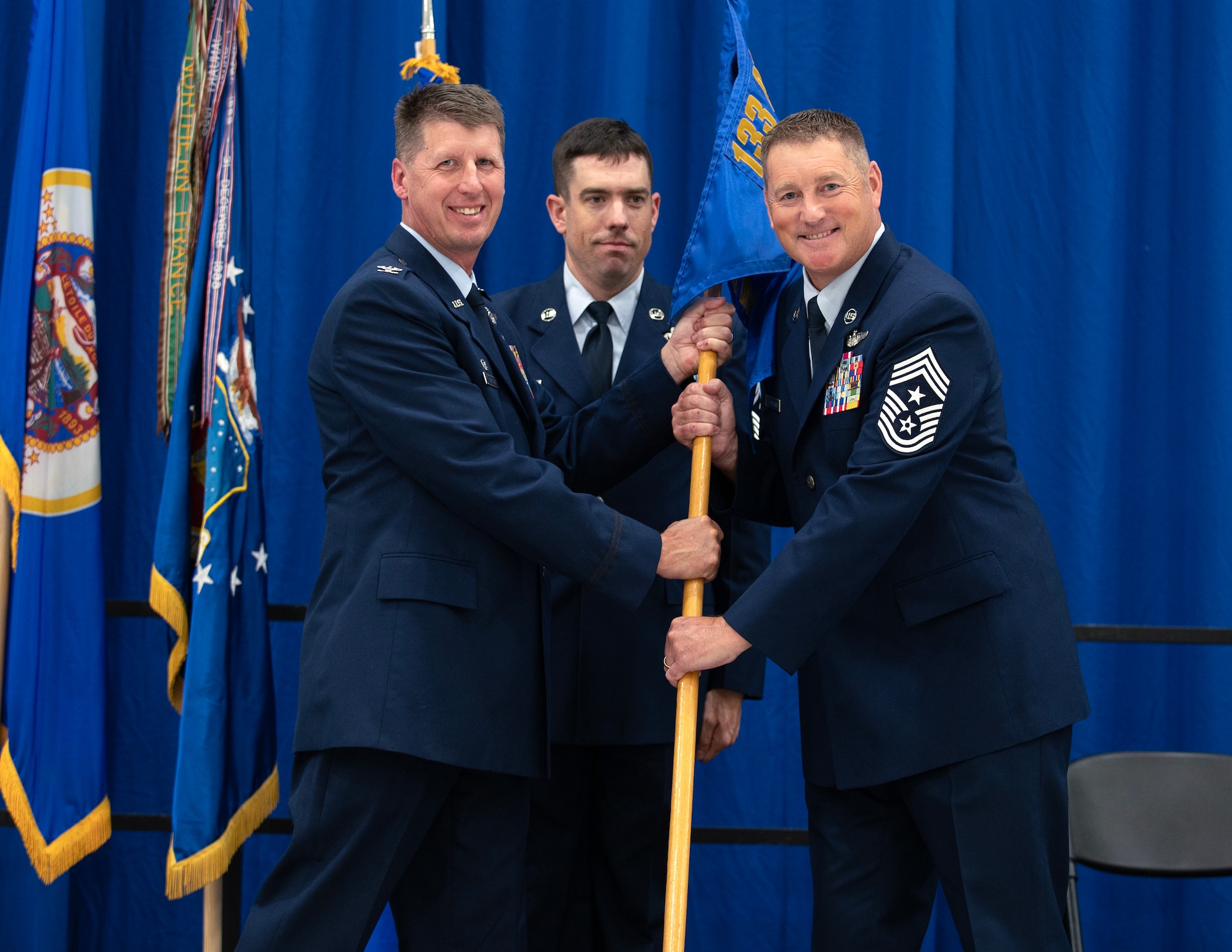 U.S. Air Force Chief Master Sgt. Richard Schumacher receives the duties of Command Chief Master Sgt. of the 133rd Airlift Wing from Col. Jesse Carlson, Commander of the 133rd Airlift Wing in St. Paul, Minn., Sept. 9, 2023.