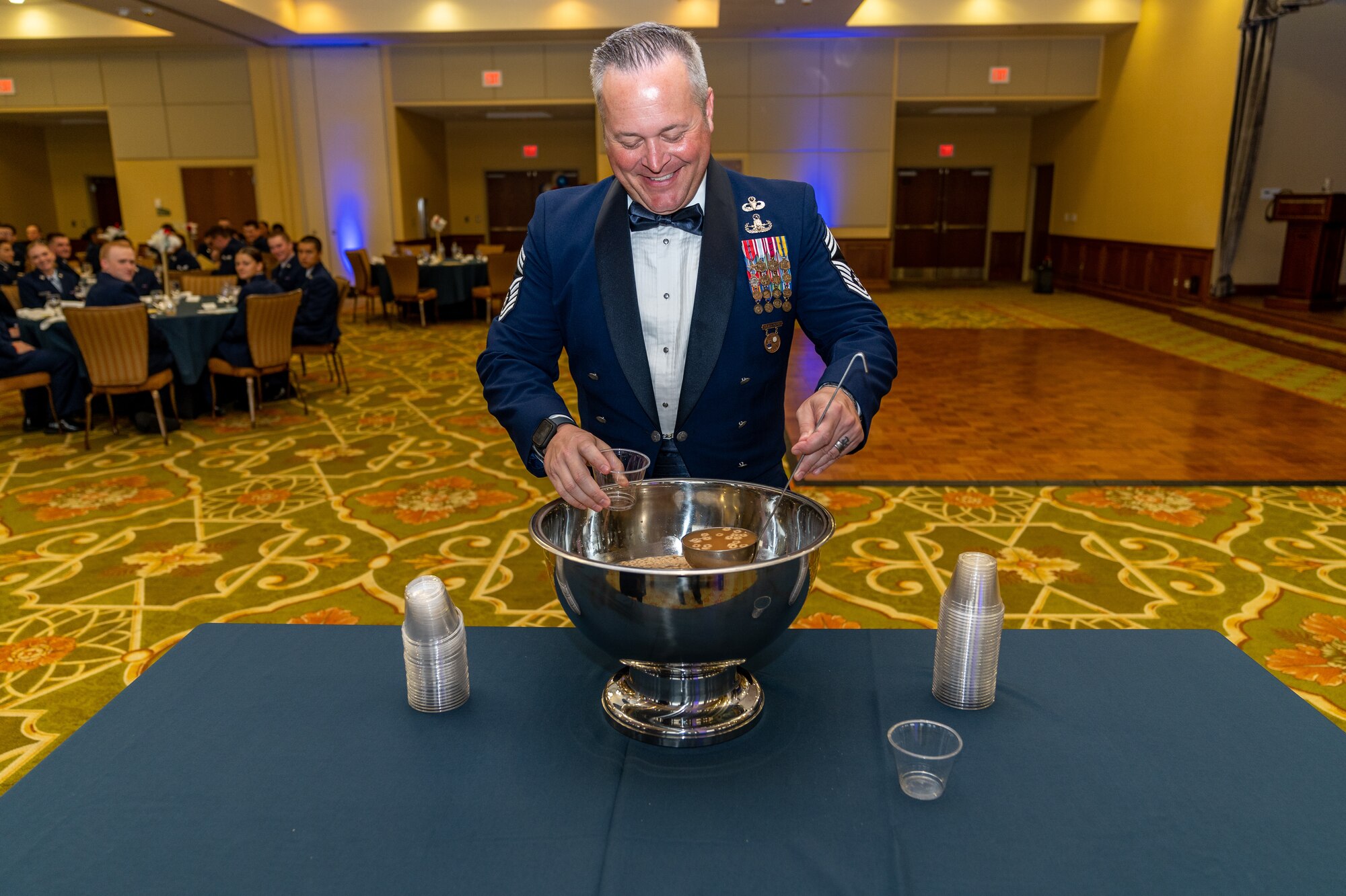 U.S. Air Force Chief Master Sgt. Jeremy Phillips, 81st Training Group senior enlisted leader, pours himself a drink from the grog bowl during the Airman’s Ball at Keesler Air Force Base, Mississippi, Sept. 14, 2023.