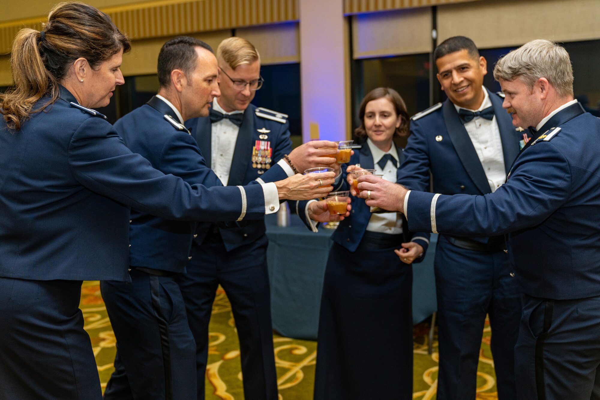 U.S. Air Force Col. Laura King, 81st Training Group commander, and squadron commanders from the 81st TRG cheers before drinking their grog during the Airman’s Ball at Keesler Air Force Base, Mississippi, Sept. 14, 2023.