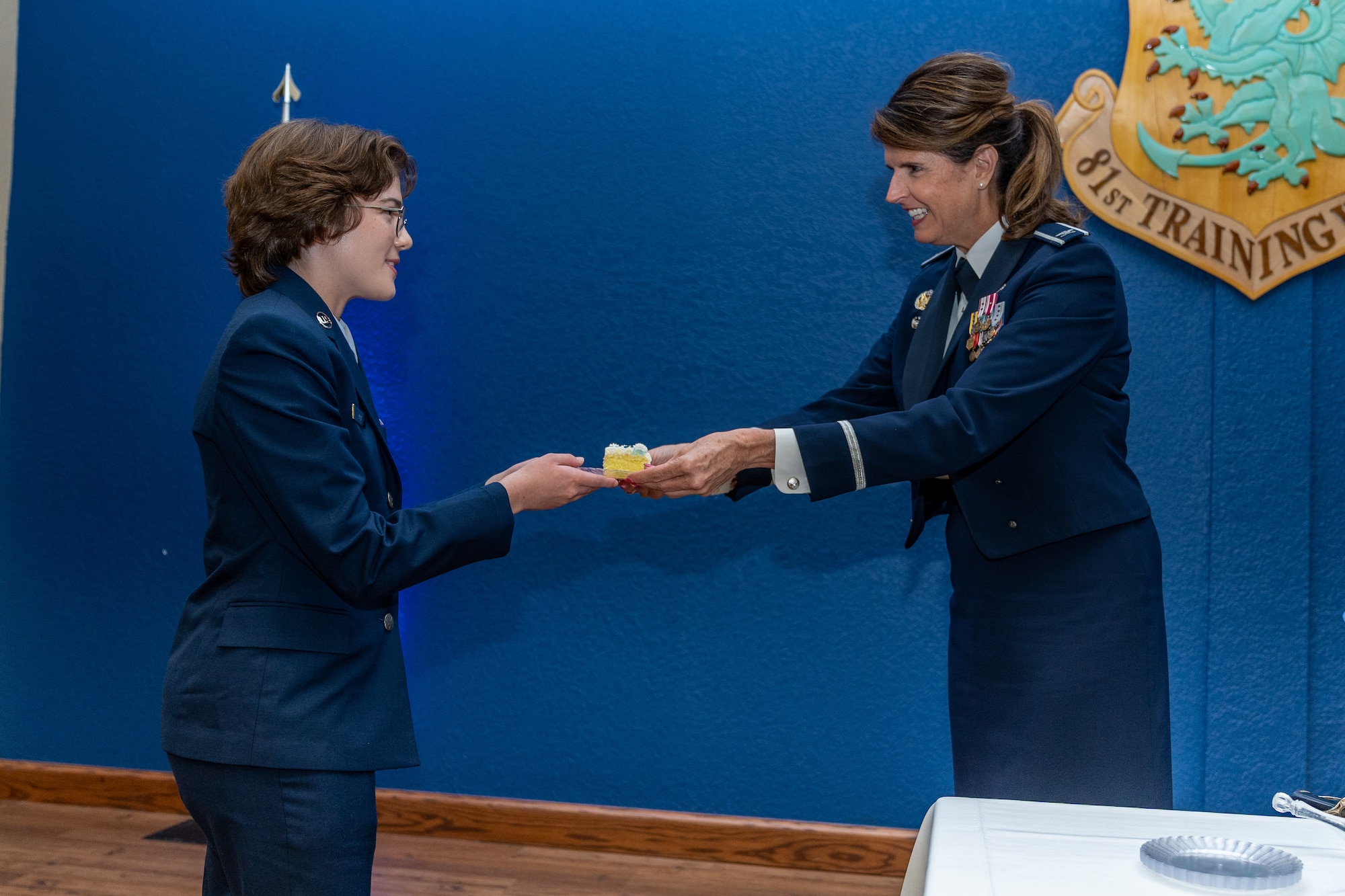 U.S. Air Force Col. Laura King, 81st Training Group commander, gives the first slice of cake to Airman Madelyn Pack, 336th Training Squadron system operations technician in training, during the Airman’s Ball at Keesler Air Force Base, Mississippi, Sept. 14, 2023.