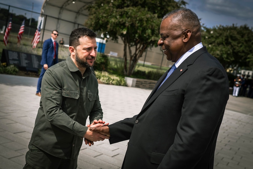 Secretary of Defense Lloyd J. Austin III shakes hands with Ukraine's president outside the Pentagon.