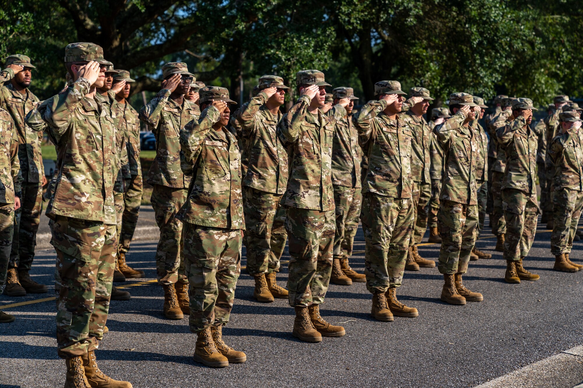 81st Training Wing Airmen present arms as the national colors are lowered during a POW/MIA Retreat Ceremony at Keesler Air Force Base, Mississippi, Sept. 15, 2023.