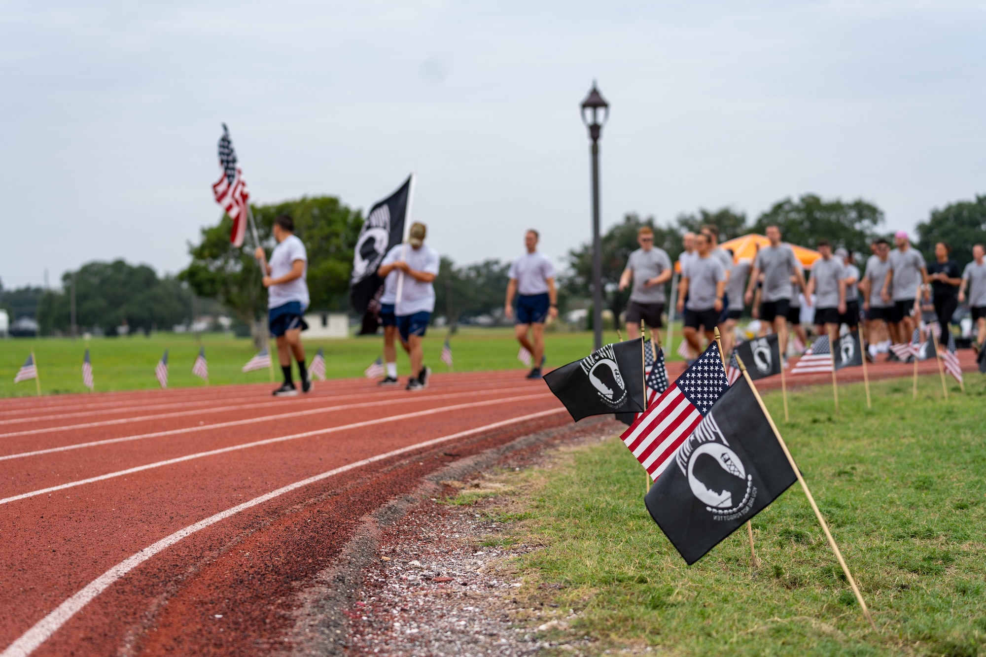 U.S. Airmen from the 81st Training Wing run on the Triangle Track in honor of National POW/MIA Recognition Day at Keesler Air Force Base, Mississippi, Sept. 15, 2023.