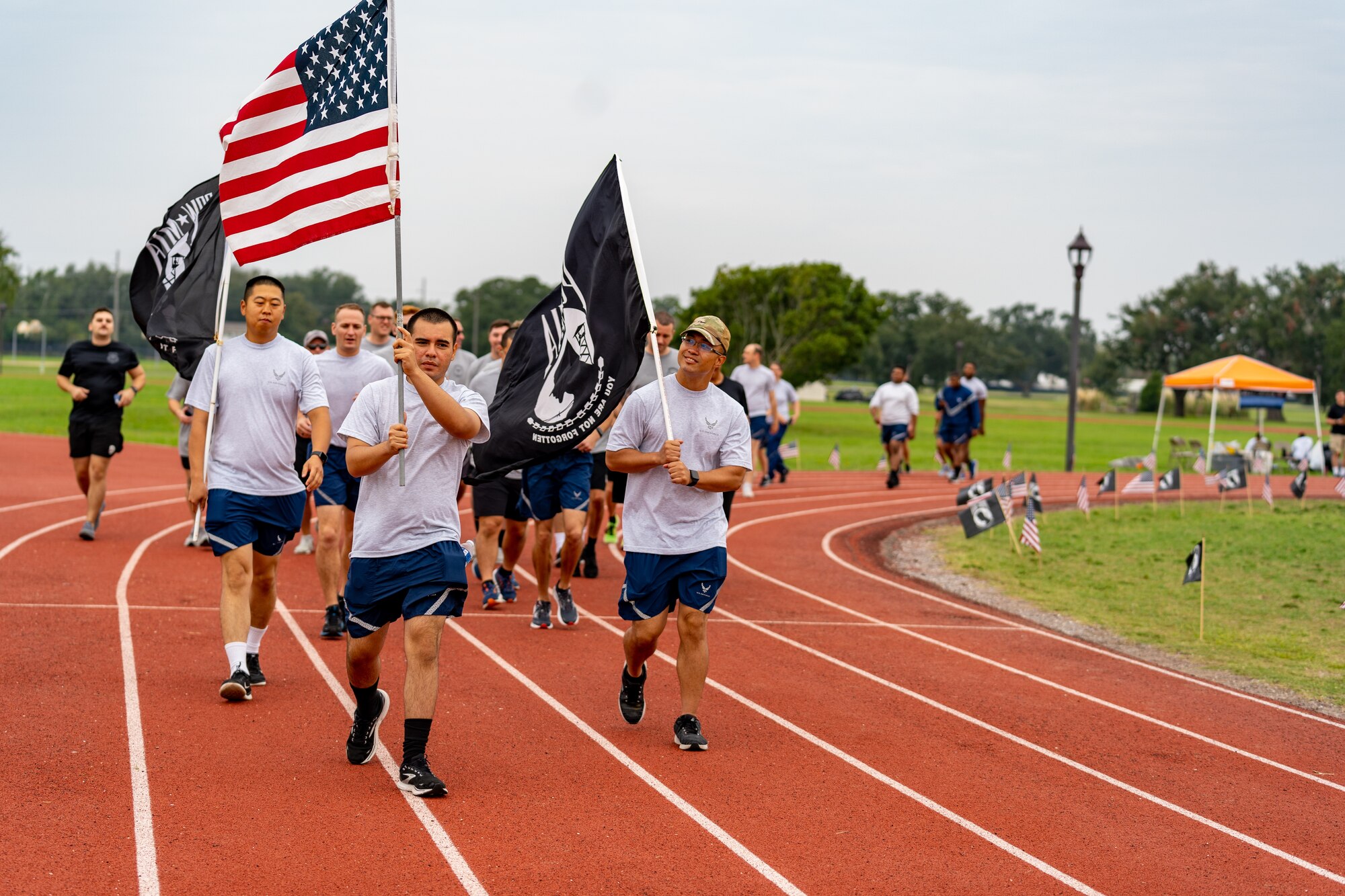 U.S. Airmen from the 81st Training Wing run on the Triangle Track in honor of National POW/MIA Recognition Day at Keesler Air Force Base, Mississippi, Sept. 15, 2023.