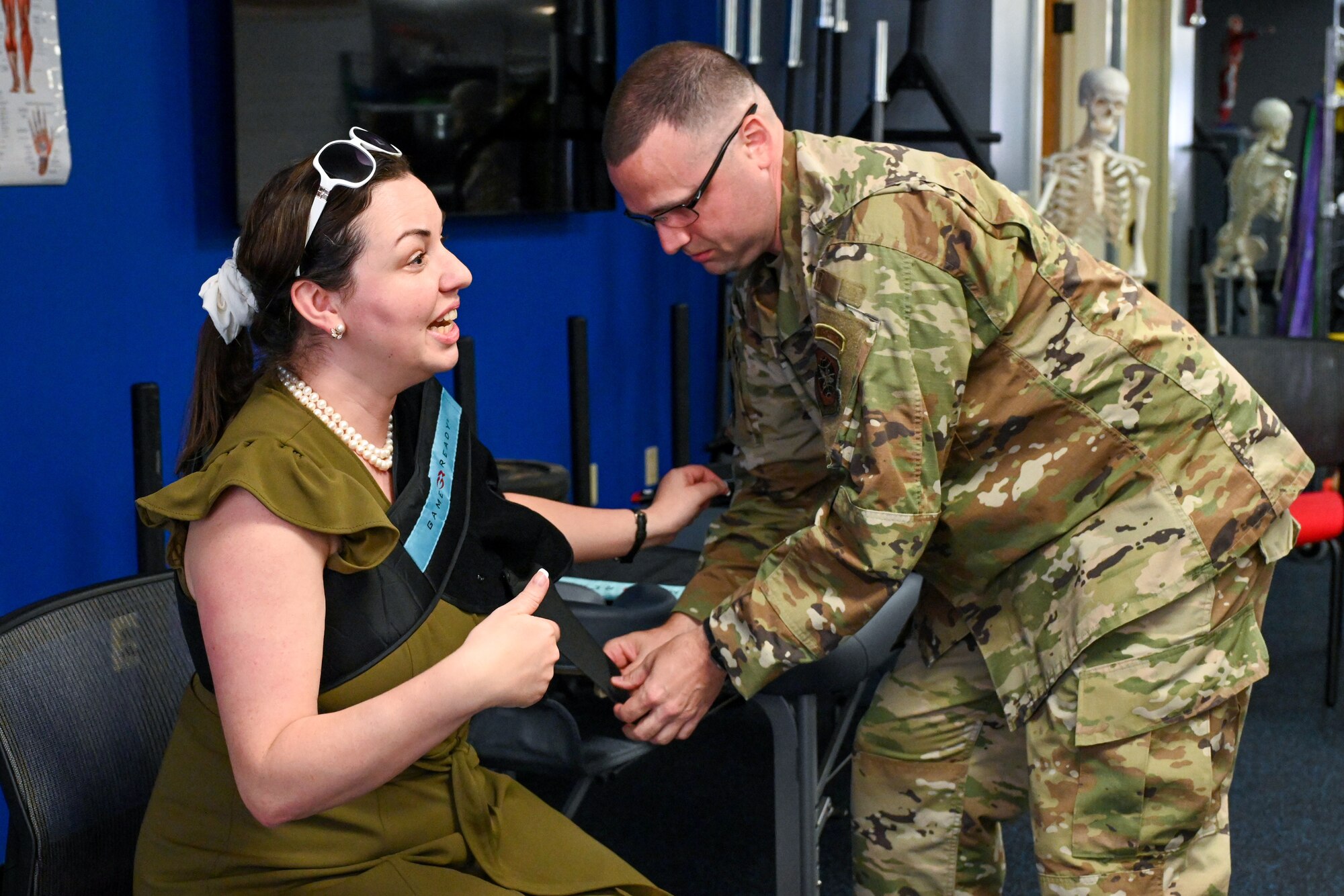 An Airman applies a cooling device to someone's arm.